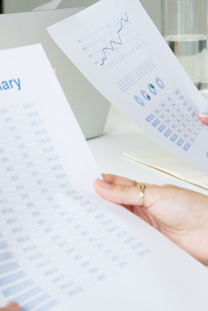 Two business professionals analyzing reports in a modern office setting.